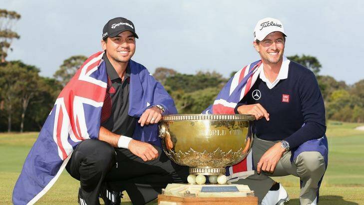 Team success: Australia's Jason Day and Adam Scott pose with the trophy after winning the teams event  of the World Cup of Golf in 2013. Photo: Quinn Rooney