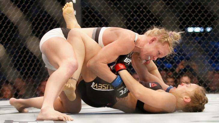 Holly Holm knocks down Ronda Rousey in UFC 193 at Etihad Stadium. Photo: Darrian Traynor