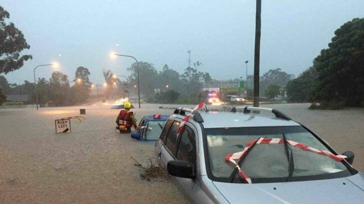 A car under water during severe weather in SEQ on Friday. Photo: Queensland Fire and Emergency Se