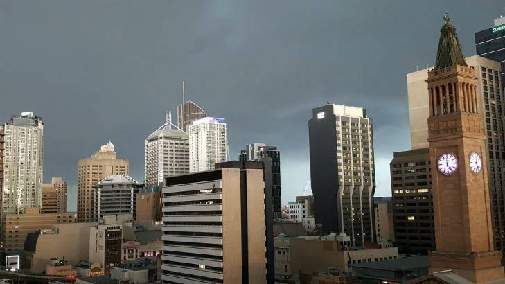 Dark skies surround Brisbane CBD as the super cell moves in. Photo: Paul Newman