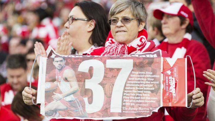 Fans support Adam Goodes with the Herald's poster. Photo: James Brickwood