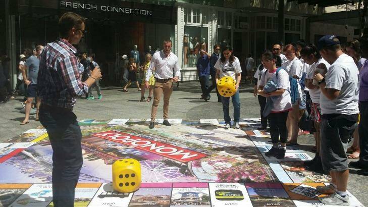 People play the new Brisbane version of Monopoly in Queen Street Mall. Photo: Supplied