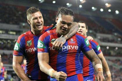 Good day's work: Joey Leilua of the Knights, right, celebrates a try with Tariq Sims. Photo: Tony Feder