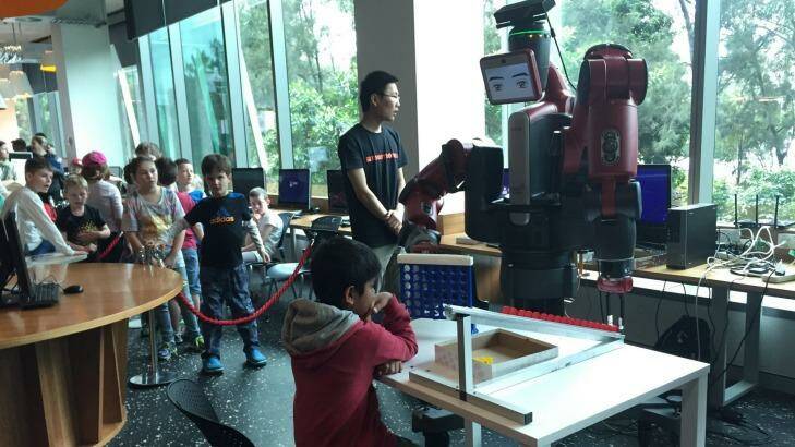 Eight-year-old Abhishek plays Connect Four with a robot named Baxter.   Photo: Supplied