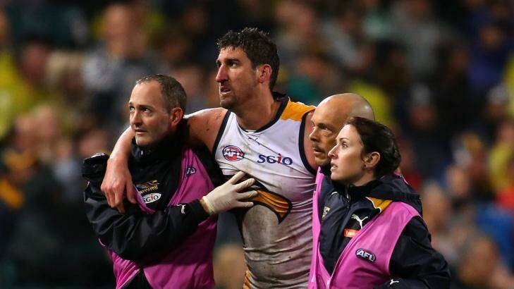 Disadvantage, Eagles: Dean Cox is helped off the ground on Friday night after being felled by Tyrone Vickery. Photo: Paul Kane