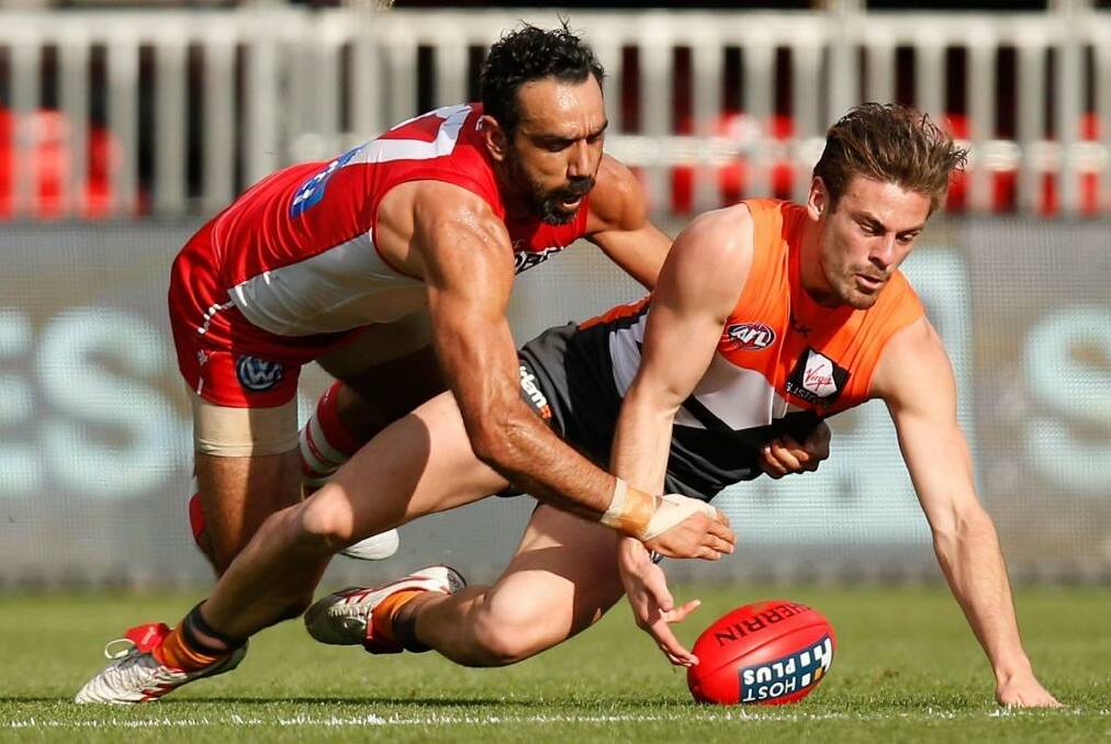Stephen Coniglio of the Giants and Adam Goodes of the Swans compete for the ball. Photo: Michael Willson/AFL Media