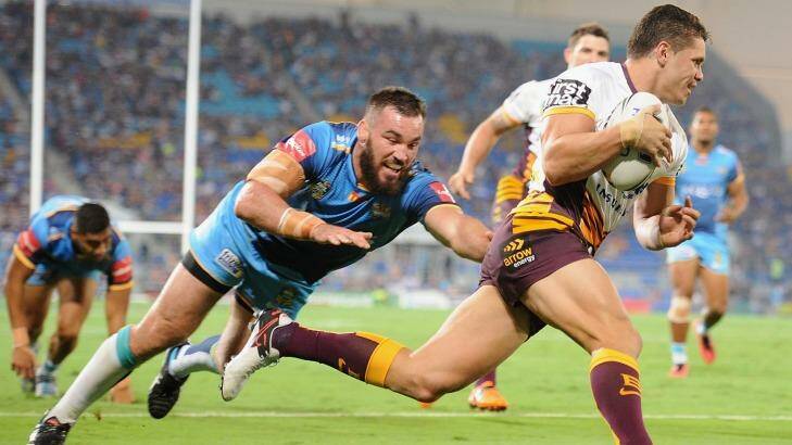 Back with a vengeance: James Roberts of the Broncos scores against the Titans. Photo: Matt Roberts