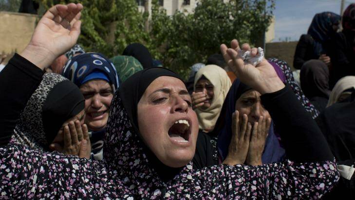 Palestinian mourners cry at the family house upon the arrival of the body of Amjad Jundi, 19, who was killed after stabbing a soldier on a bus in southern Israel. Photo: Nasser Nasser