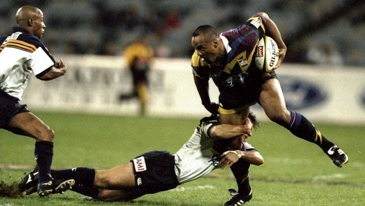 Stirling Mortlock used what become the standard technique of tackling Jonah Lomu - dive at his legs and hope he tripped over. Photo: Adam Pretty