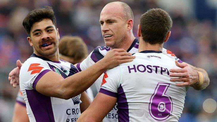 Matt White of the Storm celebrates a try with teammates at Hunter Stadium.