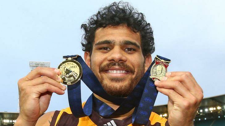 Cyril Rioli celebrates with his AFL Premiership Medal and the Norm Smith medal. Photo: Scott Barbour