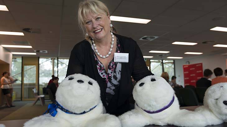 Wendy Moyle with some of the robot seals being used to help dementia patients. Photo: Michael Cranfield