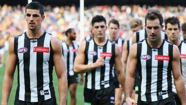 Heavy defeat: Scott Pendlebury and the Magpies leave the field.