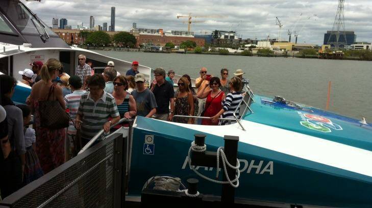 Hundreds of residents look through one of the city's new CityCats, Nar-DHA, at the opening of the new Bulimba CityCat and ferry terminal. Photo: Tony Moore