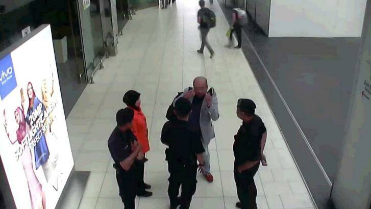 In this image from security camera footage, Kim Jong-nam gestures towards his face while talking to airport security at Kuala Lumpur International Airport, shortly before his death. Photo: Fuji TV/AP
