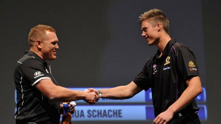 Number 2 draft pick Joshua Schache shakes hands with Juston Leppitsch, coach of Brisbane. Photo: David Mariuz