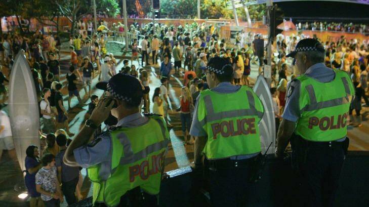 Police officers watch over the schoolies week celebrations in Surfers Paradise. The study found that revellers who did get into trouble would be most likely to turn to their friends for help. Photo: Sergio Dionisio