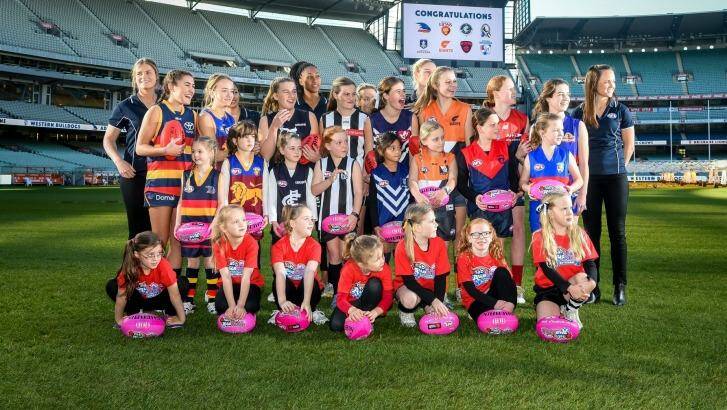 Daisy Pearce (far right) with fellow players and potential future stars at the launch of the AFL women’s league on Wednesday.  Photo: Justin McManus
