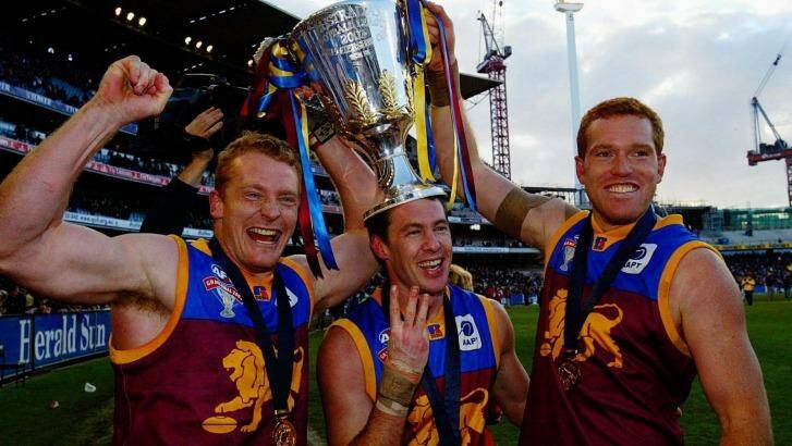 Michael Voss, Craig McCrae and Justin Leppitsch after the Lions' mighty AFL grand final win against Collingwood in 2003. Photo: Ray Kennedy