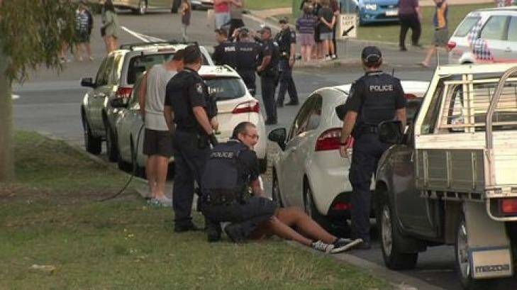 Police subdue a man after the league grand-final. Photo: Terry Royan/ <strong><A href= http://www.qt.com.au/news/crowd-brawl-sees-policeman-injured-and-12-arrested/2386095/> The Queensland Times</a></strong>