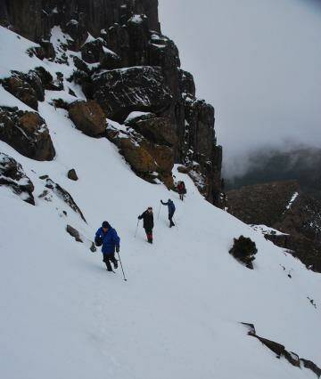 Walkers go Indian file along the side of Cradle Mountain. Photo: John Braid