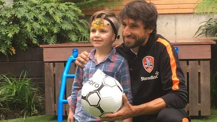Ole Walton, who was born with microtia, with Brisbane Roar's Thomas Broich at the Hear and Say Centre. Photo: Cameron Atfield