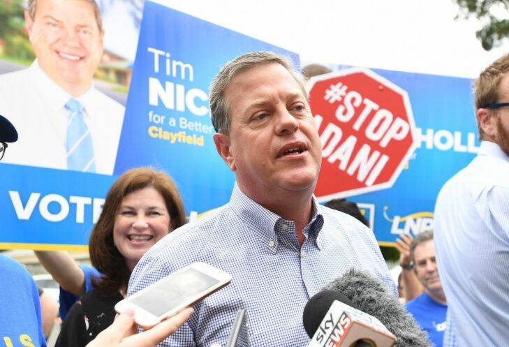 Queensland Opposition Leader Tim Nicholls is surrounded by Anti Adani protestors as he arrives to vote at St John Anglican Church in Hendra in his electorate of Clayfield on the final day of the Queensland Election campaign on Saturday, November 25, 2017. (AAP Image/Tracey Nearmy) NO ARCHIVING