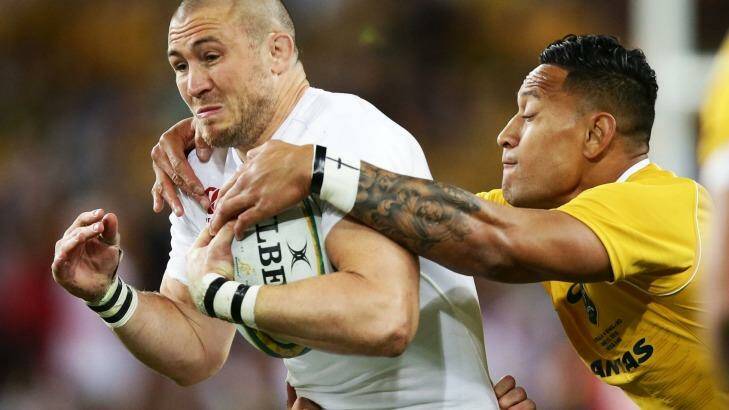 Slippery customer: Mike Brown tries to escape the clutches of Israel FOlau. Photo: Getty Images 