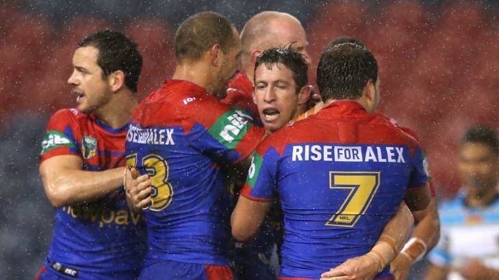 Drought-breaking win: Kurt Gidley celebrates with Knights teammates after scoring. Photo: Getty Images 