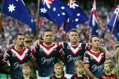 Solemn: Roosters players before the Anzac Day match. Photo: Renee McKay