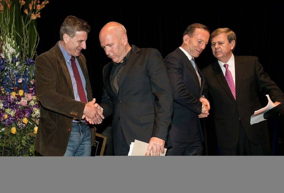 Joint fiction award winners, Steven Carroll (left) and Richard Flanagan, with the Prime Minister Tony Abbott and awards host Ray Martin. Photo: John Robenstone