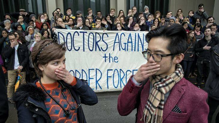 A group called Doctors Against the Border Force Act hold a silent protest at Carlton Gardens on Saturday. Photo: Luis Ascui