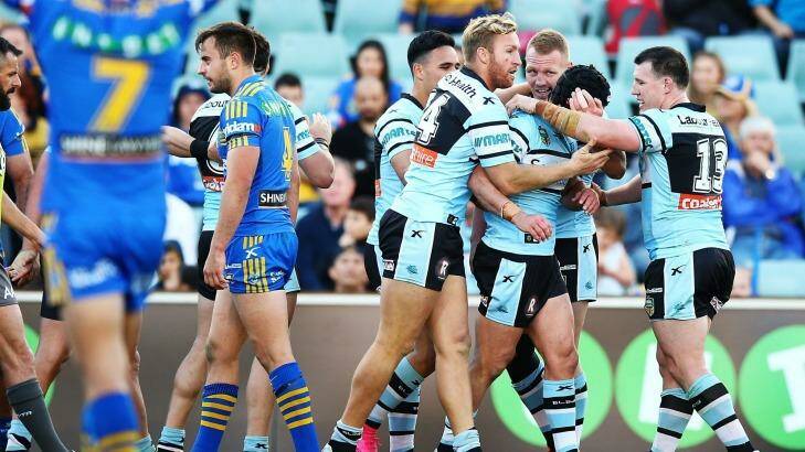 Finals bound: Sharks players celebrate a try by Michael Ennis during the round 25 win over the Parramatta Eels at Pirtek Stadium. Photo: Mark Nolan