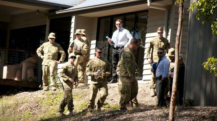 Police and ADF personnel search the Brisbane home where explosives were found.  Photo: Robert Shakespeare