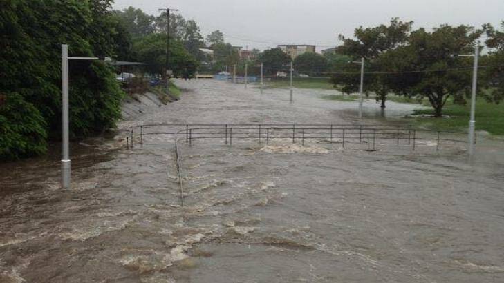 A swollen stormwater drain floods the bike path in Annerley. Photo: Louise/Higgins Storm Chasing