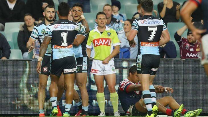 Bird flies past Roosters: Jack Bird celebrates with his Sharks teammates after scoring a try. Photo: Mark Kolbe