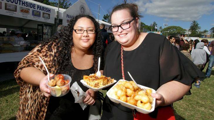 Anne Reed and Kate Steemson get a taste of the Greek food on offer at the 2015 Paniyiri Festival. Photo: Michelle Smith