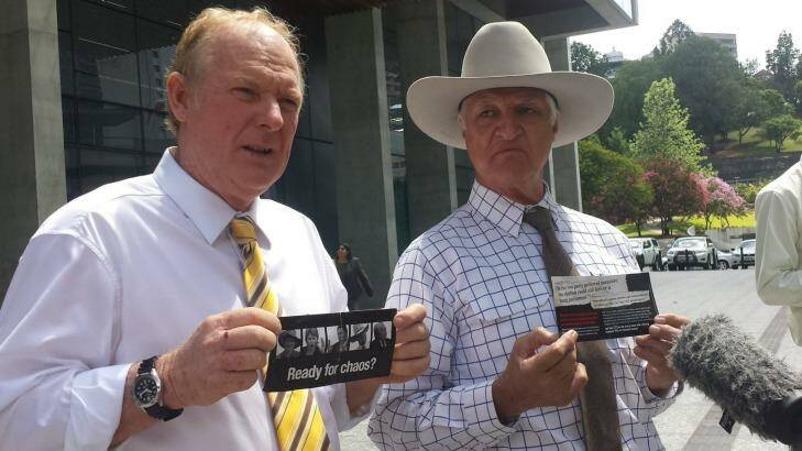 KAP state leader Shane Paulger and leader Bob Katter display LNP pamphlets outside Brisbane's Supreme Court. Photo: Kristian Silva