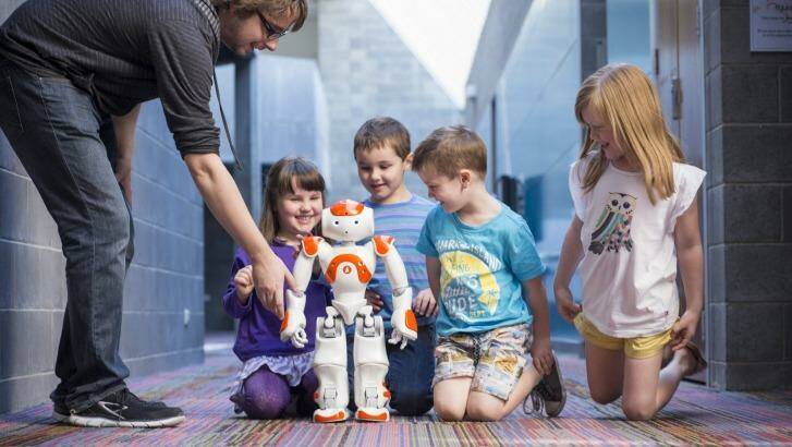 Neo Robot children for Robotronica Nao robot and children, with PhD student Gavin Suddrey. Photo: QUT