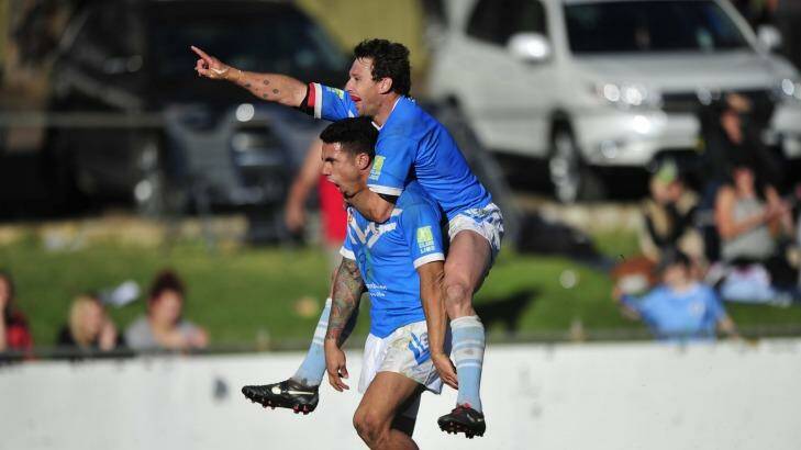 Tom Ruediger (left) celebrates with Queanbeyan Blues teammate Ben Nicoll after scoring a try in last year's grand final win over Goulburn.  Photo: Melissa Adams 