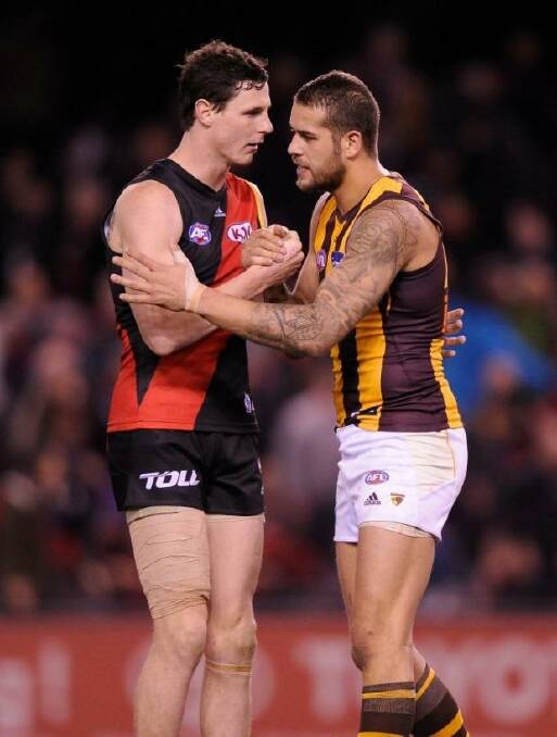 Essendon's Jake Carlisle shake with Hawthorn's Lance Franklin after the round 18 game between the teams in season 2013.  Franklin kicked eight goals in the Hawks' 143-87 win. Photo: Sebastian Costanzo