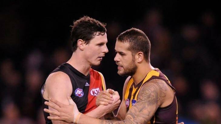 Essendon's Jake Carlisle shake with Hawthorn's Lance Franklin after the round 18 game between the teams in season 2013.  Franklin kicked eight goals in the Hawks' 143-87 win. Photo: Sebastian Costanzo