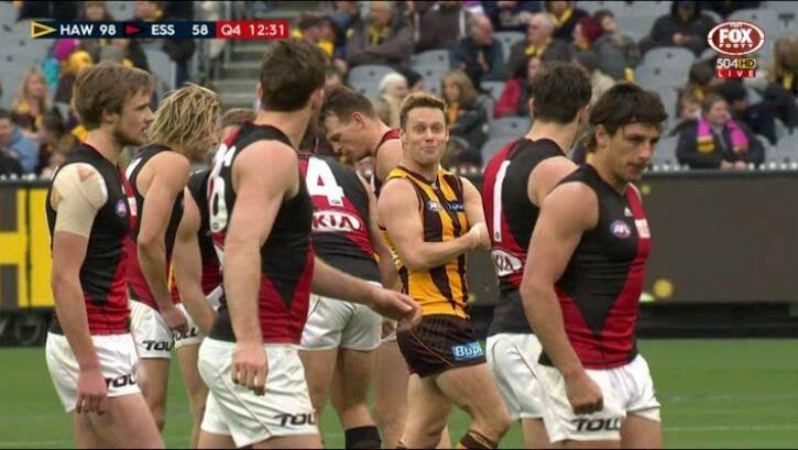 Hawthorn's Sam Mitchell taunts Essendon players, by feigning giving himself an injection. Photo: Fox Footy