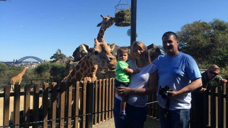 Tall friends: Anderson with his partner Rachel and son Tai enjoying the sights of Sydney at Taronga Zoo. Photo: Tom Decent