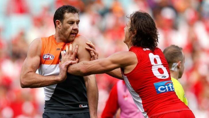 Fiery clash: Kurt Tippett and Shane Mumford wrestle during the first qualifying final between the Sydney Swans and the GWS Giants at ANZ Stadium. Photo: AFL Media/Getty Images
