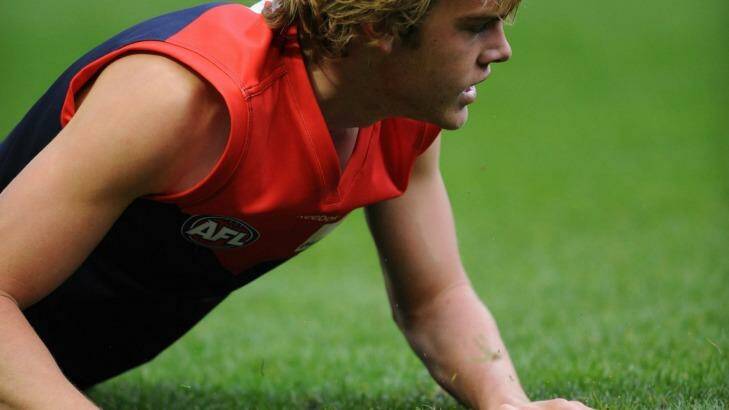 Learning curve: A young Jack Watts hits the MCG turf during his first game. Photo: Joe Armao