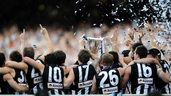 The 2010 Magpies are presented witht he premiership cup. Photo: Pat Scala