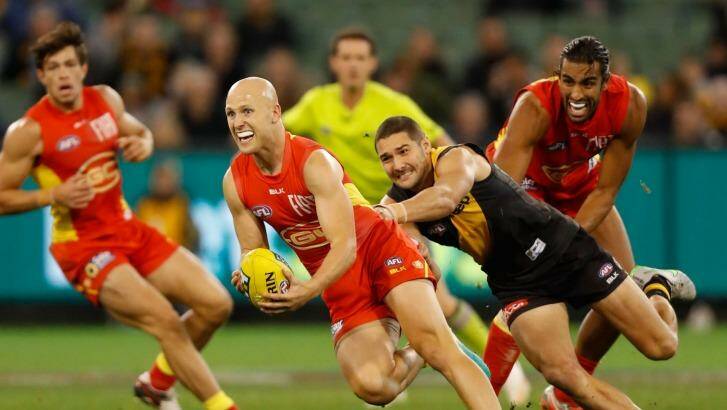 Tiger tough: Shaun Grigg chases Gary Ablett on Sunday. Photo: AFL Media/Getty Images