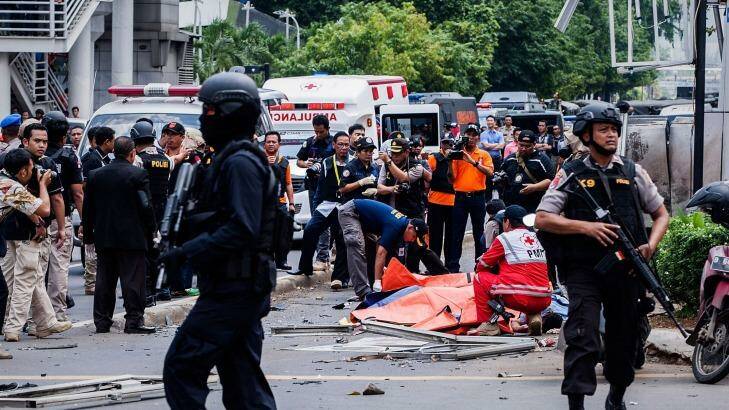 Indonesian policemen stands guard near the blast site after a series of explosions hit the Indonesia capital. Photo: Oscar Siagian