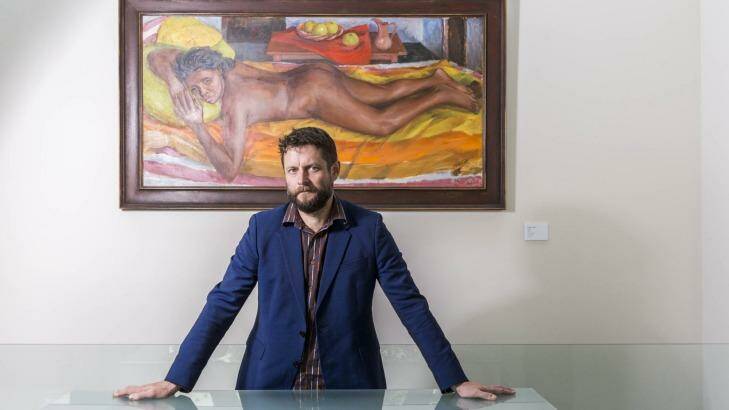 Ben Quilty with a Margaret Olley painting being shown for the first time at Philip Bacon Galleries.
 Photo: Glenn Hunt
